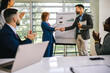 © Mediteraneo - Business man from Human Resource congratulates the new  ginger employee of their company after the job interview.
