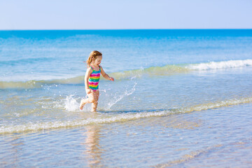 Wall Mural - Kids playing on beach. Children play at sea.