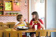 © famveldman - Kids eating fastfood. Unhealthy junk food.