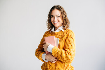 Smiling young woman holding a digital tablet, isolated on white. Ideal for themes of online learning, education technology, university admissions, and digital coursework. academic promotions.