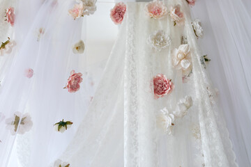 Canvas Print - Baldachin on bed. Summer pink peonies and roses flowers levitating, hanging flowers, copy space. Template, mockup. White lace curtains canopy with floral abstract pattern with spring flowers levitate	