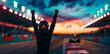 © Zaleman - With the stadium lights behind him, a racing driver celebrates victory in a race.