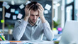 © wuttichai1983 - A man dealing with intense stress and workload at the office