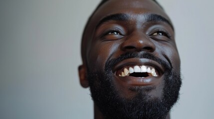 Portrait of a Joyful African American Man with a Beard Smiling Upwards