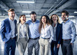 © Adisorn - Group of happy young business people standing in a row and laughing.