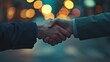 © kinara art design - Business handshake in front of blurred city lights at night