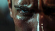 © sornram - Close-up of determined face under rain, showing intense emotion and focus with water droplets on skin.