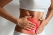 © WhimsyCreative - Woman with Abdominal Pain Holding Stomach in Red Highlighted Area