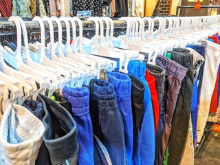 clothes are hung inside the shop for sale