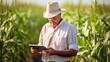 © venusvi - Farmer inputting data on a digital tablet in a cornfield
