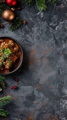 Festive winter decor and delicious dish on dark textured surface with holiday ornaments and green pine branches.