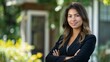 © Darya - A professional woman in a suit standing confidently outside a house, representing confidence and success. Perfect for business, lifestyle, and professional-themed projects.
