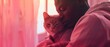© indyntk - Black man gently holding his cat, a cozy and affectionate scene