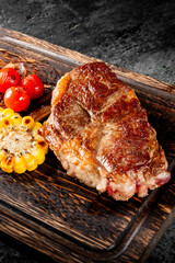 Sticker - Grilled steak with roasted tomatoes and corn on a wooden board