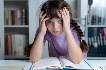 girl with hands on her head bored of studying