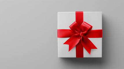 Sticker - A white gift box with a red ribbon and bow on a plain background.