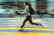© Zulkifle - Urban Rush: Woman Walking in Dynamic Cityscape. Rush Hour Blur - Woman Crossing Busy City Intersection. Rushing to work. Motion photography concept.