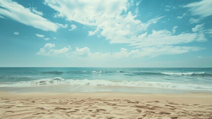 Peaceful beach with clear blue sky and gentle waves.