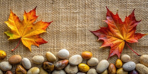 Wall Mural - Autumn leaves and pebbles on a burlap background.