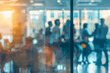 © youriy - A blurred office scene with people interacting and collaborating, seen through glass panels with warm lighting
