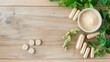 © wuttichai1983 - A variety of herbal supplements and capsules arranged with fresh herbs on a wooden surface.