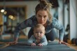 © Jane_S - Mother and baby doing yoga in the gym.