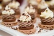 © Oksana - Chocolate pastries with whipped cream and chocolate shavings on white plate. Close-up shot. Dessert and gourmet food concept.
