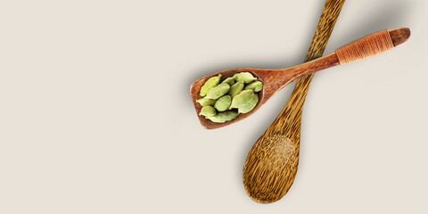 Spices and Herbs in wooden spoons Isolated on White background. Cardamom Seeds in Wooden Spoon. Top View of Spoons.