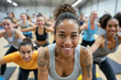 © Nedrofly - A group of women in a fitness studio, exercising and smiling, with a focus on a woman with a tattoo on her arm in the foreground.