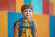 © Uliana - A young schoolboy with a backpack, standing on a vibrant and colorful background