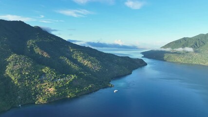 Wall Mural - Pulau Pura, a scenic volcano, sits in the middle of the Pantar Strait between Alor and Pantar, Indonesia. The island supports beautiful coral reefs and a wide variety of colorful reef fish.