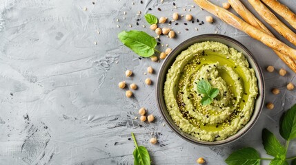 Sticker - Mixed mung bean dip with seeds mint grissini or bread sticks and green hummus on light grey background