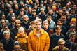 © MVProductions - Stand out from the crowd concept with blonde man standing out from large crowd of people