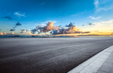 Empty asphalt road and cloudscape by the sea