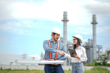 Wall Mural - Planning engineering and project leader working and check Plans at Industrial Site on power plant. Survey location on site. 