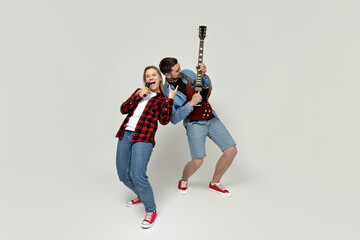 Wall Mural - Young man and woman playing the guitar