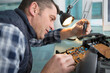 © auremar - man working on an electronic circuit board with a screwriver