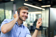 © ty - Smiling friendly handsome young male call centre operator