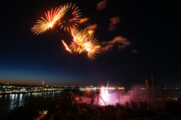 Wall Mural - Holiday fireworks above water with reflection on the black sky background