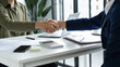 © mojo_cp - Executives business partnership handshake in meeting room
