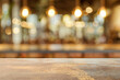 © oksa_studio - Empty table top with blurred restaurant background, ideal for product placement