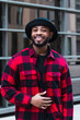 © BUDDHA - Man portrait. Style. Handsome Afro American guy in red jacket is looking at camera and smiling
