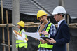 © Prathankarnpap - Engineers and businessman planning development details about project at construction site.