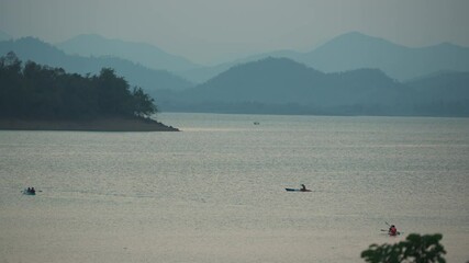 Wall Mural - Tourist canoeing on Kaeng Krachan reservoir in the evening at Phetchaburi