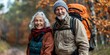 © ckybe - Experienced elderly married couple on a trekking adventure.