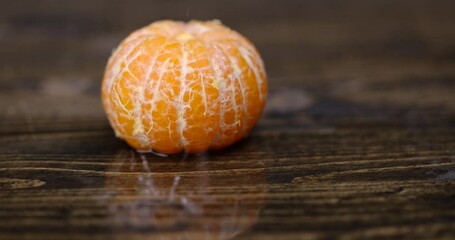 Canvas Print - peeled ripe sweet tangerine, mandarin fruit without shell on a wooden blackboard