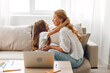 © SHOTPRIME STUDIO - Mother and daughter bonding time on the couch with a laptop, exploring and learning together