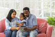 © Art_Photo - Portrait of enjoy happy love black family african american father and mother with little african girl child smiling and play having fun moments good time in room at home