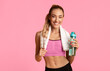 © Prostock-studio - Hydration. Fitness Girl Holding Water Bottle And Towel Posing On Yellow Studio Background. Empty Space