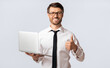 © Prostock-studio - Cool Online Job. Happy Businessman Holding Laptop Gesturing Thumbs-Up Over White Studio Background.